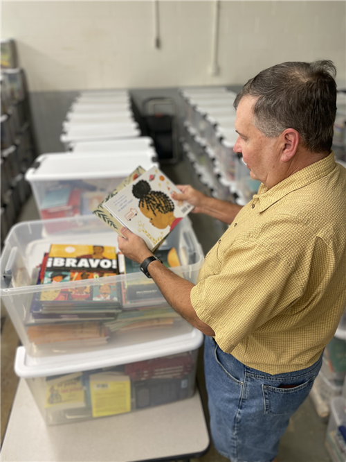 Dr. Mark Rodgers sorts the Spanish books to add them to the newly created Spanish section. 